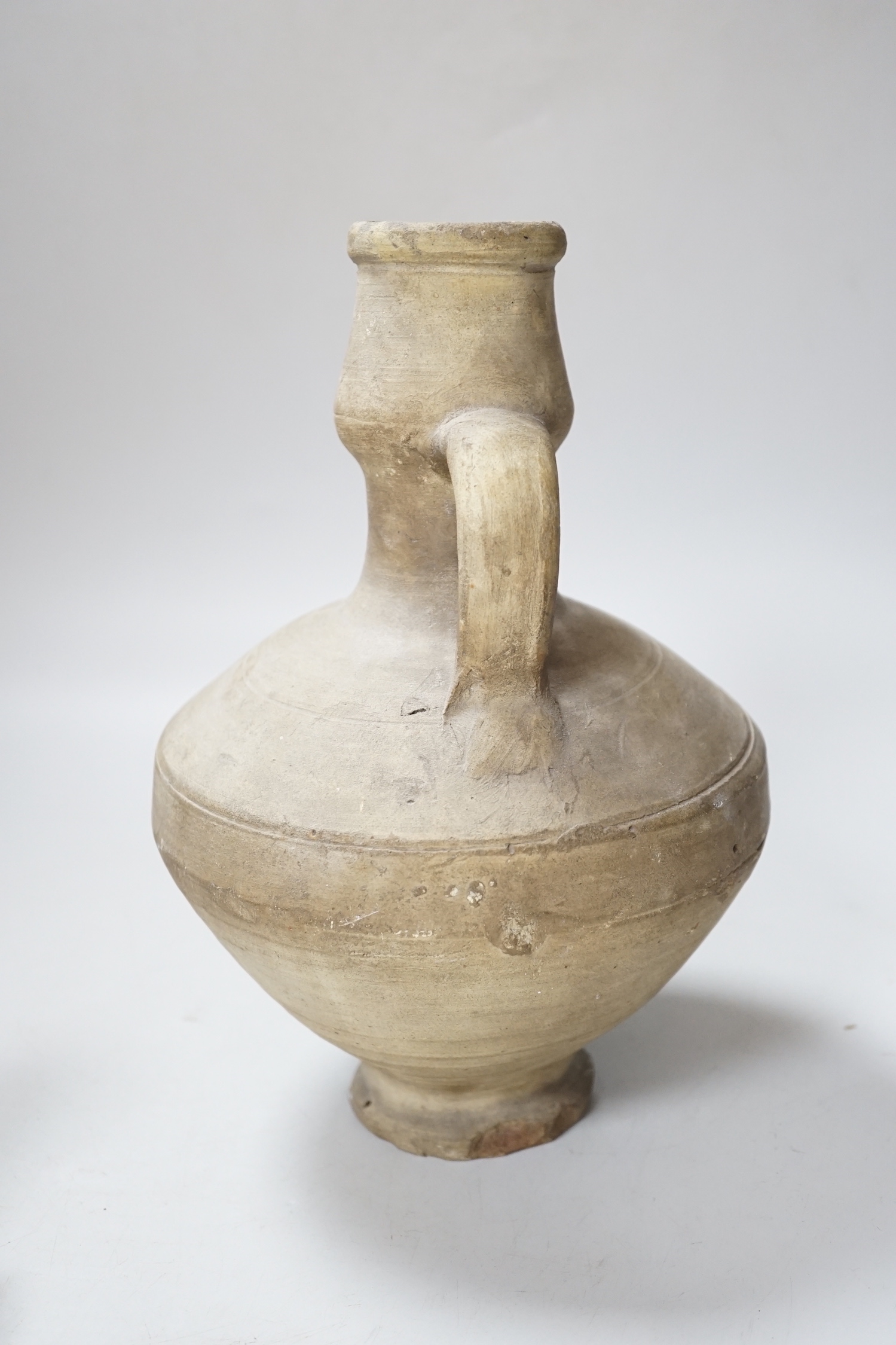 An Egyptian style alabaster model of a sphinx and a twin handled pottery vase, the largest 25cm high